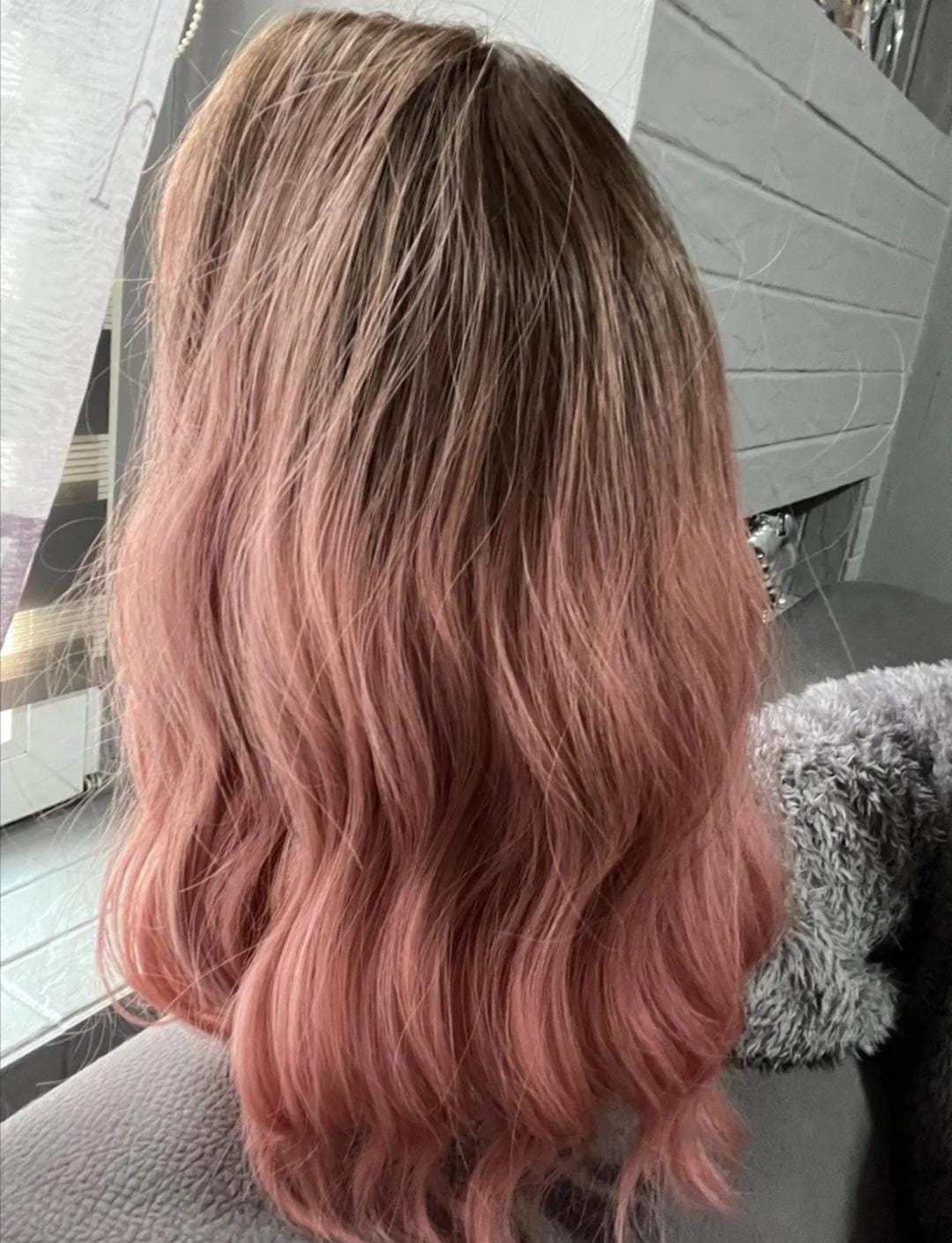 Short wavy pink synthetic wig with dark roots and bangs