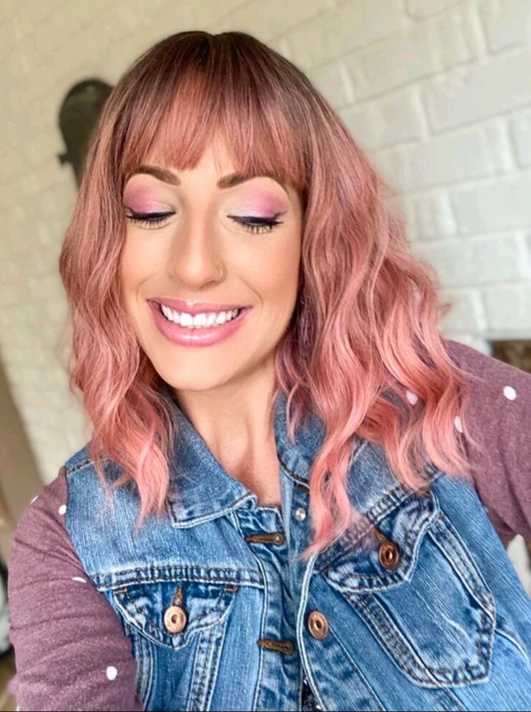 Short wavy pink synthetic wig with dark roots and bangs
